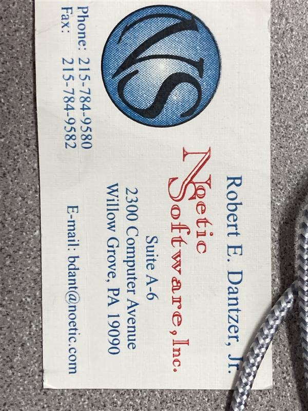 Historic Noetic Software business card featuring the original circular NS logo